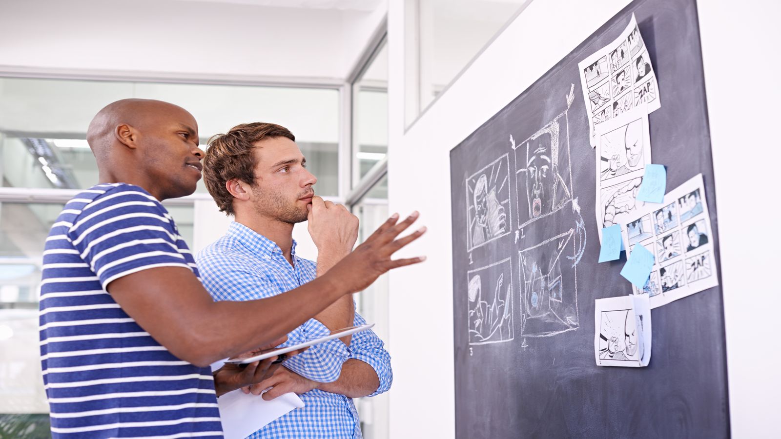 A developer staring at a whiteboard full of system design diagrams