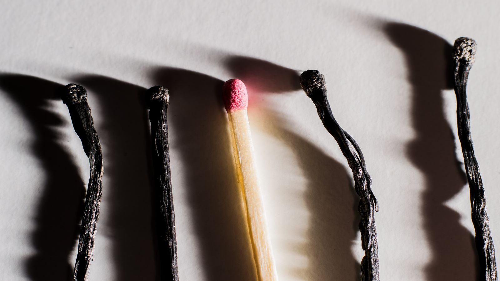 A developer staring at a blank screen with coffee cups piling up